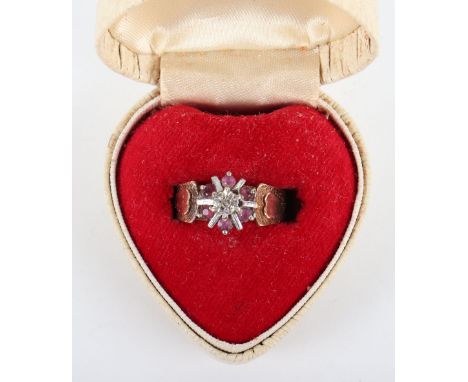 A 1970’s 9ct gold, ruby and diamond ring, the band decorated with hearts, 3.7g