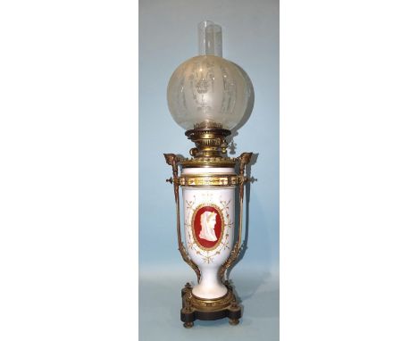 A Victorian gilt metal and opaque glass oil lamp decorated with female cameos, having later etched glass globe, 69cm, includi