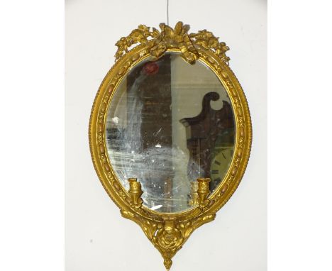 *Please note, all starred lots are sold at no reserve.*An oval gilt gesso girandole, 70 x 46cm and an oval gilt gesso wall mi