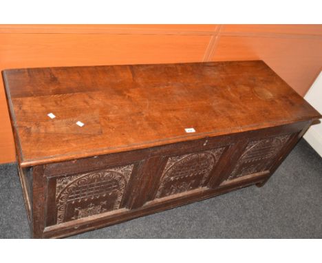 An early 18th century oak blanket box, three panel front, carved with lunettes, c.1720
