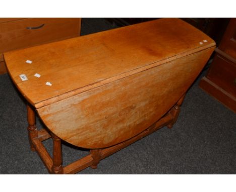 A 20th century light oak dropleaf table, oval top, turned supports, 71cm high, 114cm wide, (126cm  fully extended)