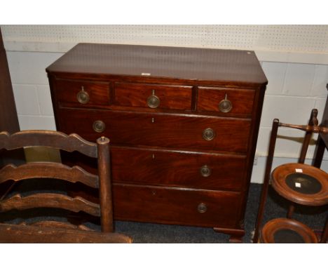 A mahogany chest of drawers, three short over three long, reeded panel pilaster uprights, brass swing handles