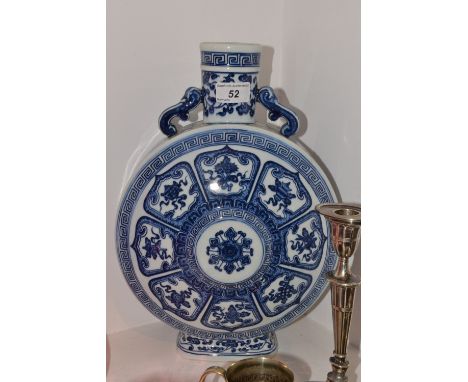 A Chinese blue and white moon flask, decorated with lotus leaf panels each with precious objects, S-scroll handles 36cm high