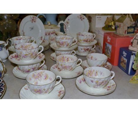 A Kay and Co Worcester twelve setting tea service, painted with floral sprays, comprising tea plates, cups and saucers, teapo