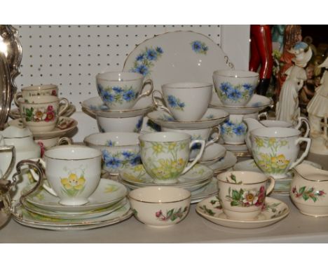 A Colclough tea service, for six, decorated with blue flowers;  a set of six Maddock and Sons coffee cups;  a Royal Stafford 