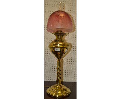 A Victorian cranberry oil lamp, acid etched shade, embossed reservoir, twisted stem. domed base, c.1880