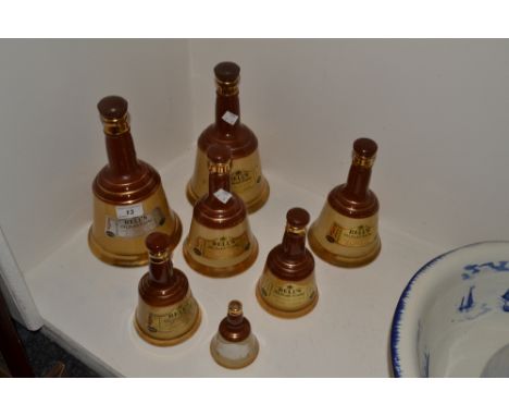 A graduated set of three Wade whisky bells; another set of four 