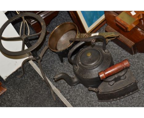 Metal Ware - a cast iron kettle on trivet;  a large ladle;  a flat iron;  a cast iron saucepan, the handle cast with Wasbroug