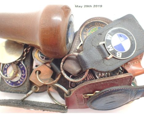 Tray of enamel car keyrings and a BMW wooden gear knob