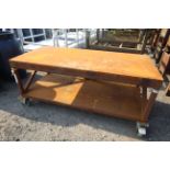 Metal two tier workshop trolley on wheeled base, approx. 32" deep x 71" wide x 31" high.