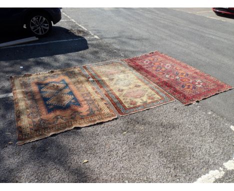 Three Persian rugs to include a Bokhara and two with geometric motif A/F, largest 197cm x 107cmLocation:If there is no condit