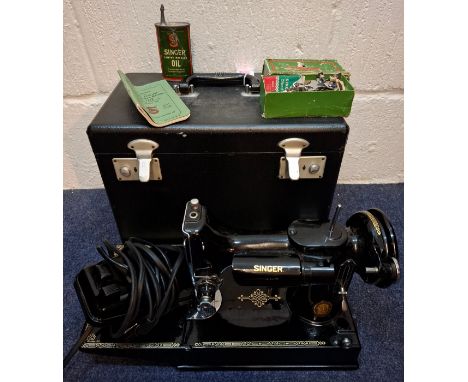 A 1951 Singer 221K electric sewing machine in original fitted case with accessories and manual, serial no:EH001170, spool cas