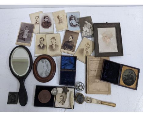Monochrome photos and other collectables to include a small handled mirror, a mourning brooch, a brooch decorated with mother