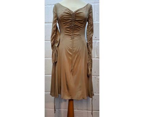 Versace- A gold silk fitted dress with ruched front and sleeves, knee length with rear zip fastening, European size 38. Locat