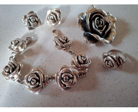 A Thai silver jewellery suite comprising a pendant, earrings, a ring and a bracelet in the form of roses, 47g. Location:If th