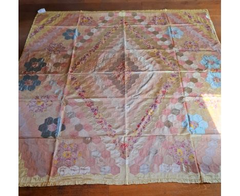 A mid 20th Century double, hand stitched quilted eiderdown having a yellow border with a geometric pattern of hexagonal colou