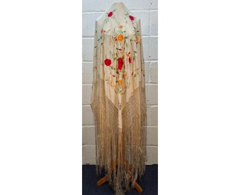 An early 20th Century cream silk embroidered crinoline shawl with extra long cream silk tassels, approx size 48" x 48" not in