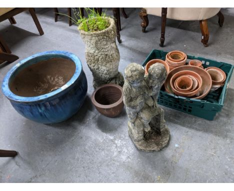 A selection of garden plant pots and statuary, to include a weathered concrete owl planter, terracotta plant pots, a blue gla