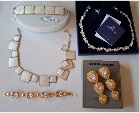 Swarovski- A modern silver tone and white crystal necklace in original box, together with a 1980's Monet gold tone and white 
