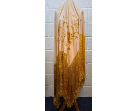 A 20th Century embroidered cream silk shawl with gold coloured extra long tassels and embroidered floral design, measures app