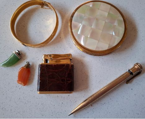 A small mixed lot comprising a gold tone and mother of pearl compact, a gold tone propelling pencil, a vintage German lighter