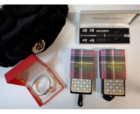 Two Vivienne Westwood packs of boxed playing cards, a cased green laser pointer (not tested), a Russian deerstalker style hat