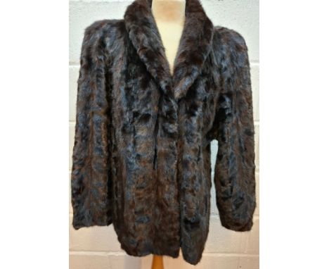 A 1980's black mink fur jacket having bellow sleeves, side pockets and a shawl collar, approx 44" chest x 28" long. Location: