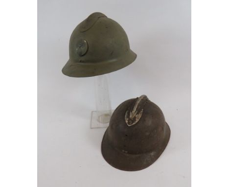 Two French M1927 Steel Helmetsconsisting green painted, one piece crown and brim with attached top comb.  Front pressed flami