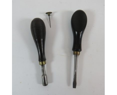 Two Victorian Gun Toolsconsisting black ebonised handled, steel screwdriver ... Continental steel nipple key.  The turned woo