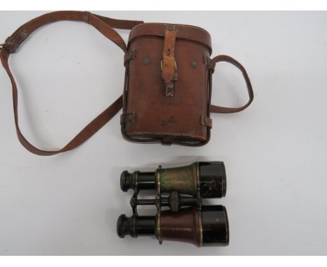 Pair of WW1 Dated Field Binocularsblackened brass, extendable lenses with broad arrow stamps.  Leather covered body (1 side a