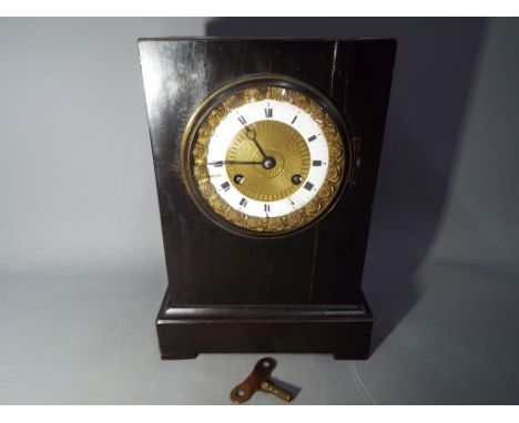 A mantel clock with key.  This lot must be paid for and removed no later than close of business on Friday
