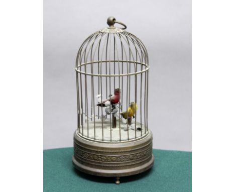BIRD CAGE AUTOMATON, with a pair of feathered, singing birds amongst enamelled metal foliage, inside a domed cage, the base w