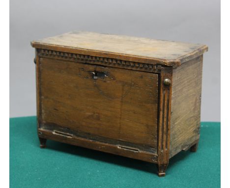 CONTINENTAL WALNUT MINIATURE FALL FRONT COMMODE, 19th century,the fall front enclosing an arrangement of drawers, flanked by 