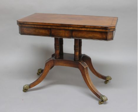 REGENCY MAHOGANY CARD TABLE, the canted rectangular top with ebony stringing, twisting to reveal a well, on a four column sup