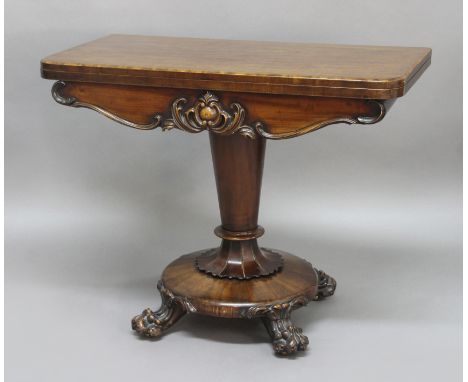 VICTORIAN MAHOGANY FOLD OUT CARD TABLE, with foliate carved frieze, tapering column and lion paw feet, height 71cm, width 90c