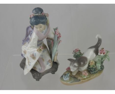 A Lladro Porcelain Figurine depicting a seated Geisha together with a Lladro figurine depicting a cat and toad. (2)