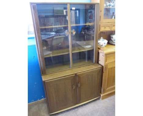 An Ercol Elm Glazed Front Display Cabinet, the cabinet having two shelves with cupboard below, approx 90 x 43 x 160 cms. 