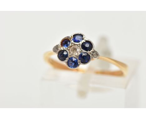 A YELLOW METAL DIAMOND AND SAPPHIRE CLUSTER RING, of a flower design, set with a central single cut diamond, in a surround of