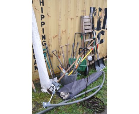 A COLLECTION OF GARDEN TOOLS and two parasols without bases