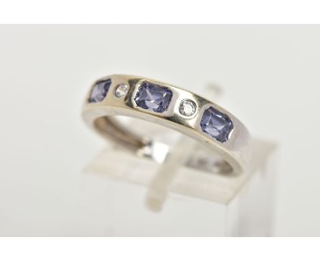 A 9CT WHITE GOLD HALF ETERNITY RING, designed with a row of three rectangular cut light purple cubic zirconia interspaced wit