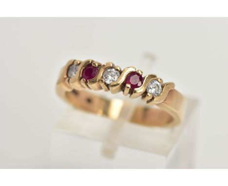 A 9CT GOLD HALF HOOP RING, designed with a row of three circular cut cubic zirconia interspaced with two circular cut rubies,