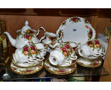 A ROYAL ALBERT OLD COUNTRY ROSES TEA SET, comprising a tea pot, height 18cm, milk jug, sugar bowl, a bread and butter plate, 