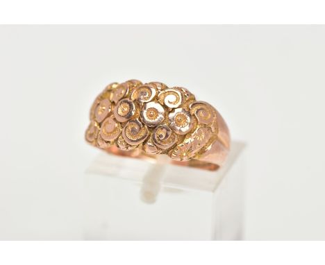 A 9CT GOLD DOME RING, a wide band detailing a floral and scrolling pattern, approximate width 10mm, hallmarked 9ct Birmingham