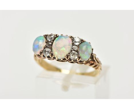 AN EARLY 20TH CENTURY OPAL AND DIAMOND DRESS RING, designed with three oval opal cabochons, showing flashes of blue, green an