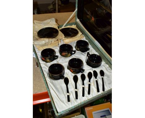 A BOXED BLACK LACQUER TEA SET comprising a mid-20th Century lacquer tea set in a fitted case, six cups, saucers, spoons and t