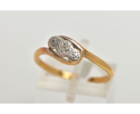 AN AF YELLOW METAL DIAMOND RING, of a cross over design with a central illusion set single cut diamond, plain polished split 