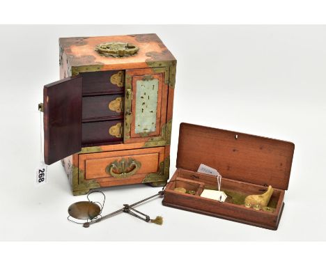 A WOODEN CHINESE JEWELLERY BOX AND A CASES SET OF SCALES, a two door one draw wooden jewellery box, detailed to the doors wit