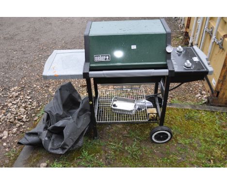 A WEBER SILVER GAS BARBECUE with two burners, side extension, undershelf, tools and cover enclosure, width 60cm