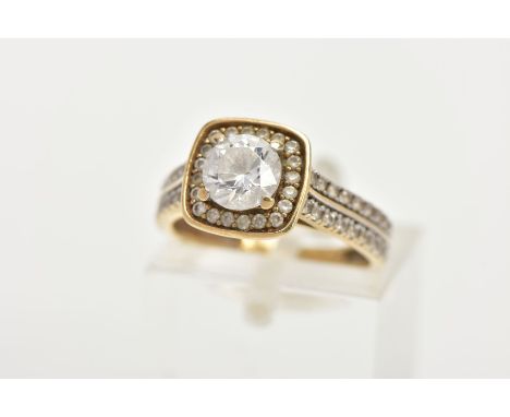 A 9CT GOLD CUBIC ZIRCONIA DRESS RING, centring on a colourless circular cut cubic zirconia, within a square mount also set wi