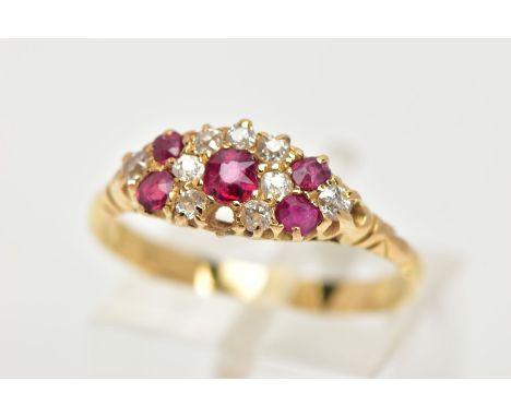 A YELLOW METAL RUBY AND DIAMOND RING, of a marquise shape set with a central circular cut ruby interspaced with old cut diamo